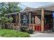 Madlife restaurant with outdoor seating, pergola, and red chairs at 116 Via Roma, Woodstock, GA 30188