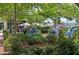 Inviting outdoor seating area with blue chairs surrounded by lush greenery at 116 Via Roma, Woodstock, GA 30188