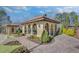 Elegant pool house features an arched entryway, tile roof, beautiful landscaping, and stone pathways at 116 Via Roma, Woodstock, GA 30188