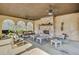 Relaxing pool house interior with stone fireplace, ceiling fans, and comfortable seating area at 116 Via Roma, Woodstock, GA 30188