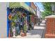 Eclectic storefront with colorful decorations and unique items displayed at 116 Via Roma, Woodstock, GA 30188