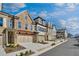Attractive new townhome exteriors showcasing multiple levels and attached garages at 116 Via Roma, Woodstock, GA 30188