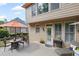 Enjoy this peaceful back deck, perfect for entertaining with an orange umbrella, grill, and lounge chair at 227 Cedarhurst Dr, Canton, GA 30115