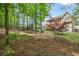 Mature trees frame the backyard, creating a private outdoor oasis with a deck and room to play at 227 Cedarhurst Dr, Canton, GA 30115