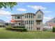 Back exterior of the home featuring a deck, bay window, and well-maintained lawn at 227 Cedarhurst Dr, Canton, GA 30115