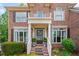 Inviting entryway with a classic brick facade, decorative wreath, and well-maintained shrubbery at 227 Cedarhurst Dr, Canton, GA 30115