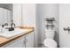 Bright bathroom features white cabinetry, wood-look countertops and black fixtures at 2716 Suwanee Se Way, Marietta, GA 30067