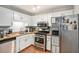 Well-equipped kitchen with white cabinetry, stainless steel appliances, and butcher block countertops at 2716 Suwanee Se Way, Marietta, GA 30067
