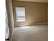 Bright bedroom with soft carpeting, neutral paint, and a window providing natural light at 3648 Lake Estates Way, Atlanta, GA 30349