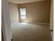 Cozy bedroom with soft carpeting, neutral paint, and a window providing natural light at 3648 Lake Estates Way, Atlanta, GA 30349