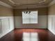 Formal dining room featuring decorative molding, hardwood floors and a chandelier for an elegant touch at 3648 Lake Estates Way, Atlanta, GA 30349