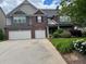 Charming two-story home with a well-maintained lawn and complemented by a beautiful landscaped yard at 3648 Lake Estates Way, Atlanta, GA 30349