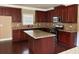 Well-equipped kitchen with dark wood cabinetry, granite countertops, and stainless steel appliances at 3648 Lake Estates Way, Atlanta, GA 30349