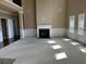 Spacious living room with fireplace, carpet, high ceilings, and large windows offering abundant light at 3648 Lake Estates Way, Atlanta, GA 30349