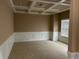 Neutral-toned room featuring a coffered ceiling, classic wainscoting, and bright natural light from a window at 3648 Lake Estates Way, Atlanta, GA 30349