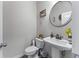 This half bathroom features a pedestal sink, decorative mirror, and modern fixtures at 6237 Thorncrest Dr # 10, Tucker, GA 30084