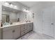 Bathroom featuring double vanity, framed mirror, decorative lighting and tiled floor at 6237 Thorncrest Dr # 10, Tucker, GA 30084