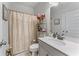 This bathroom features a vanity, large mirror, tub with curtain and modern fixtures at 6237 Thorncrest Dr # 10, Tucker, GA 30084