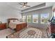 Spacious bedroom features a ceiling fan and ample natural light from large windows at 6237 Thorncrest Dr # 10, Tucker, GA 30084