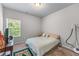 This bedroom features carpet floors, window for natural light and a closet at 6237 Thorncrest Dr # 10, Tucker, GA 30084