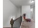 Hallway with hardwood railing and balusters, and carpeted floor at 6237 Thorncrest Dr # 10, Tucker, GA 30084