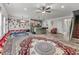 Open-concept living room with a large rug, a staircase, and seamless access to the kitchen and dining areas at 6237 Thorncrest Dr # 10, Tucker, GA 30084
