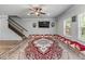 Bright living room featuring a unique rug, comfortable seating, a ceiling fan, and staircase access to upper floors at 6237 Thorncrest Dr # 10, Tucker, GA 30084