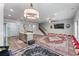Bright open living space featuring unique floor seating, a staircase, seamless connection to kitchen, and modern lighting at 6237 Thorncrest Dr # 10, Tucker, GA 30084