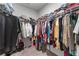 Walk-in closet with clothing hung on rods and items stored on shelves at 6237 Thorncrest Dr # 10, Tucker, GA 30084