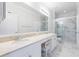 Modern bathroom featuring marble tile, double vanity, and glass-enclosed shower at 10 Perimeter Summit Ne Blvd # 3109, Atlanta, GA 30319