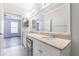 Bathroom with double sinks, marble floors, and a doorway to the bedroom at 10 Perimeter Summit Ne Blvd # 3109, Atlanta, GA 30319