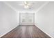Empty bedroom with wood-look flooring, neutral walls, two windows, and a ceiling fan at 10 Perimeter Summit Ne Blvd # 3109, Atlanta, GA 30319