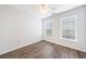 Bright bedroom featuring wood floors, white walls, and natural light from two windows at 10 Perimeter Summit Ne Blvd # 3109, Atlanta, GA 30319