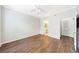 Bedroom with hardwood floors, ceiling fan, and a view into an ensuite bathroom at 10 Perimeter Summit Ne Blvd # 3109, Atlanta, GA 30319