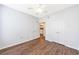 Bedroom with wood floors, closet, ensuite bathroom, two windows, and a ceiling fan at 10 Perimeter Summit Ne Blvd # 3109, Atlanta, GA 30319