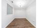 Versatile empty room with hardwood floors, neutral walls, and a unique glass block window at 10 Perimeter Summit Ne Blvd # 3109, Atlanta, GA 30319