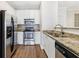 Modern kitchen featuring stainless appliances, granite counters, and hardwood floors at 10 Perimeter Summit Ne Blvd # 3109, Atlanta, GA 30319