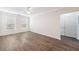Spacious living room featuring wood floors, two windows, and a closet with double doors at 10 Perimeter Summit Ne Blvd # 3109, Atlanta, GA 30319