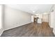 Open living area with a view of the kitchen and front door, featuring wood flooring and white walls at 10 Perimeter Summit Ne Blvd # 3109, Atlanta, GA 30319