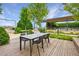 Stylish outdoor dining area with a table and chairs, set on a wooden deck surrounded by greenery at 10 Perimeter Summit Ne Blvd # 3109, Atlanta, GA 30319