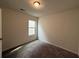 Cozy bedroom with neutral carpet, a window offering natural light, and ample space for furniture and relaxation at 2285 Crossrail Dr, Atlanta, GA 30349