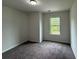 Cozy bedroom featuring neutral walls, carpet flooring, and a window with natural light at 2285 Crossrail Dr, Atlanta, GA 30349