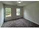 Comfortable bedroom with two windows offering natural light, neutral carpet, and ample space for furniture and personalization at 2285 Crossrail Dr, Atlanta, GA 30349