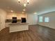 Modern kitchen featuring white cabinets, granite countertops, stainless steel appliances, and an island overlooking the living area at 2285 Crossrail Dr, Atlanta, GA 30349