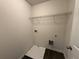 Functional laundry room with overhead shelving and space for laundry appliances at 2285 Crossrail Dr, Atlanta, GA 30349