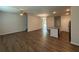 Open-concept living area featuring hardwood floors, a ceiling fan, stairs and a kitchen with an island, creating a spacious environment at 2285 Crossrail Dr, Atlanta, GA 30349