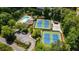 Aerial view of the community pool and tennis courts, surrounded by lush greenery and mature trees at 4281 Chimney Lake Ne Dr, Roswell, GA 30075