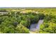 Stunning aerial view of a lake surrounded by mature trees and lush landscaping, creating a private oasis at 4281 Chimney Lake Ne Dr, Roswell, GA 30075
