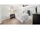 Serene bedroom with a plush bed, neutral tones, and decorative arched windows at 4281 Chimney Lake Ne Dr, Roswell, GA 30075