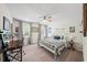 Bright bedroom featuring a plaid bedspread, a ceiling fan, and plenty of natural light at 4281 Chimney Lake Ne Dr, Roswell, GA 30075